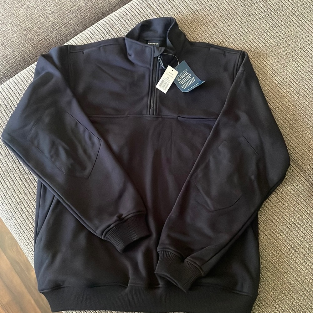 Two Large Navy 3/4 Zips. Side pockets, two chest pockets, and shoulder pouch’s.